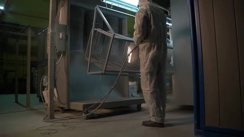 Two men in protective suits treated with a chemical solution metal structure. Stock Footage 116777141