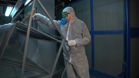 Two men in protective suits treated with a chemical solution metal structure. Stock Footage 116777188