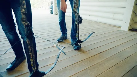 Two men pull the strings of the crossbows Stock Footage 81924405