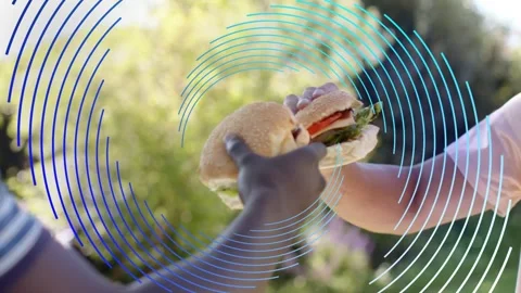 Two men reaching in bringing burgers to center garden, animated circles Stock Footage 333911516
