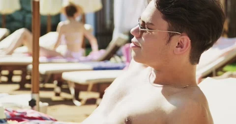 Two men relaxing near pool. Travelling and having holiday in the luxury hotel Stock Footage 158370871