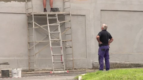 Two men repairing the facade Stock Footage 158700876