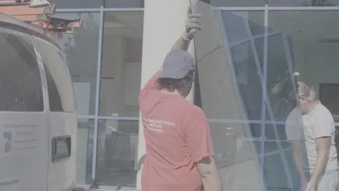 Two Men Replacing a Large Blue Glass Window - RAW Stock Footage 209289604