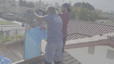 Two Men Replacing a Skylight Window on a Roof Peeling the Protective Film (RAW) Stock Footage 212417456