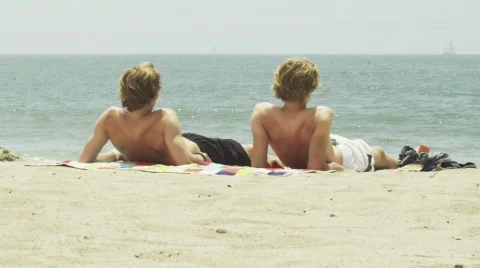 Two men resting on the beach 스톡 동영상 797536