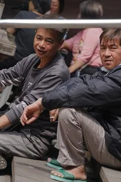 Two Men Resting on Temple Steps Gazing Through Handrail at Cisheng Temple Fotos Stock