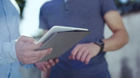 Two Men Reviewing Data on a Tablet, Outdoor Business Meeting, Close Up Shot Vídeo Stock 341442958