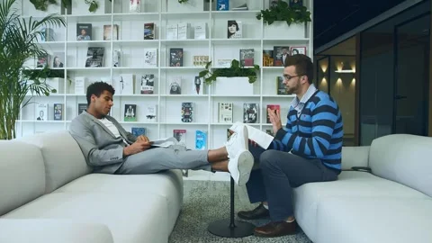 Two Men Reviewing Documents and Talking in Modern Office Warsaw Stock Footage 340265325