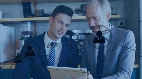 Two men reviewing tablet in cafe right man showing and expanding network node Stock Footage 331634719