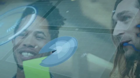 Two men reviewing tech data, holographic UI appearing, charts rotating, holding Stock Footage 333477679