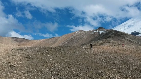 Two men ride along the mountain path. Stock Footage 83713328