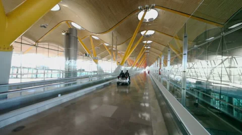 Two men ride by cart in empty hallway at Madrid Barajas Airport Video stock 31204684