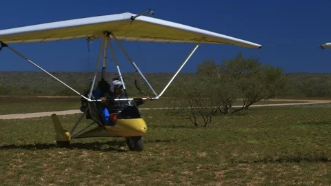 Two men riding in a mechanical hang glider Stock-Footage 100346783