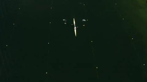 Two men row a two-seater boat on the lake Vidéo 261184102