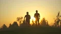 The two men running outdoor on the beautiful sunset background. slow motion 4k or 4k+ Resolution