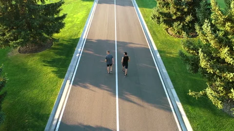 The two men running on the park road Vidéo 97666552