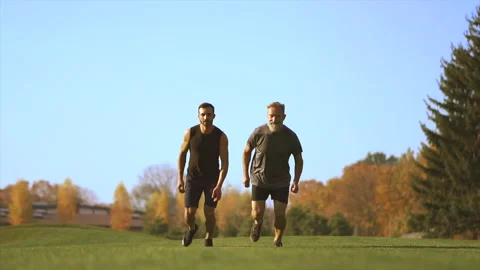 The two men running in the park. slow motion Stock Footage 97721878