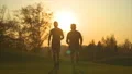 The two men running in the park on the sunset background. slow motion 4k or 4k+ Resolution