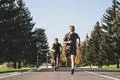 The two men running on the road in the park Photo