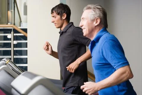 Two men running on a treadmill Stock Photos