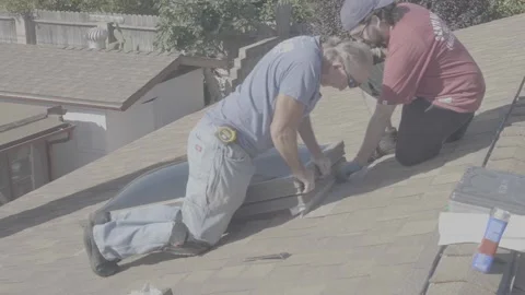 Two Men Screwing in a Large Skylight Window on a Rooftop (RAW) Stock Footage 212417699