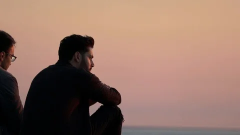 Two men by the sea during the sunset. Stock Footage 103482971