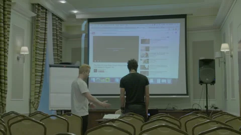 Two Men Setting Up a Projector Presentation in a Conference Room Stock Footage 341862961
