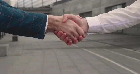 Two men shake hands, conclude successful contract agreement, sign of support for Stock Footage 164840596