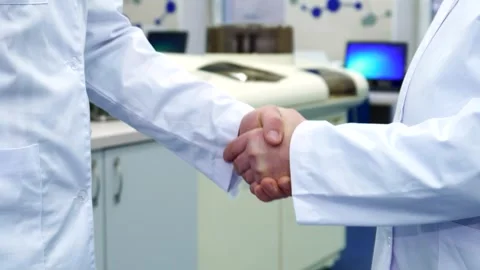 Two men shake hands at the laboratory Stock Footage 311516002