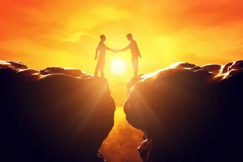 Two men shake hands over precipice between two rocky mountains at sunset. bus Stock Photos