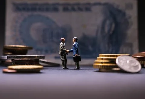 Two men shaking hands in front of a large bank note Stock Photos