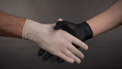 Two men shaking hands in gloves closeup Stock Footage 129420437