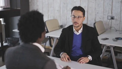 Two men sit at the office, talking and negotiate Stock Footage 81019732