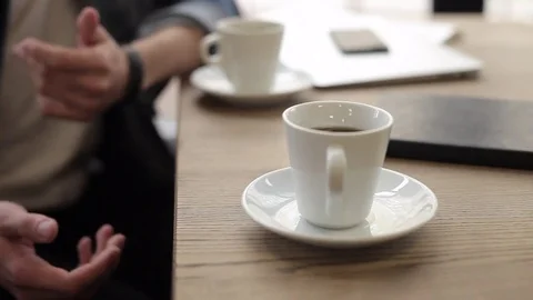 Two men sitting in cafe drinking coffee Stock Footage 74855438