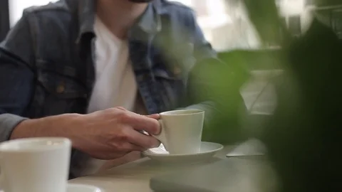 Two men sitting in cafe drinking coffee Stock Footage 74855447