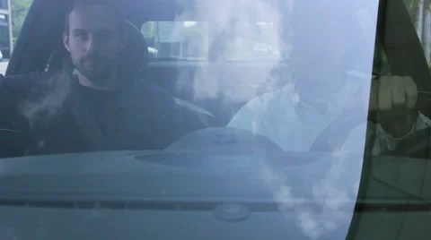 Two men sitting in car driving down the road Stock Footage 41495683