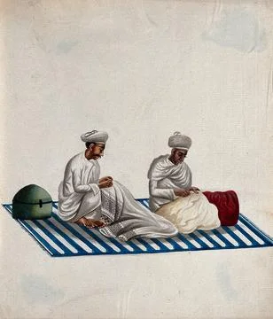 Two men sitting on a carpet, engaged in needle work. Gouache painting by an.. Illustrazione stock