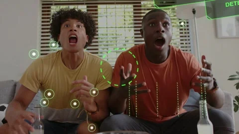 Two men sitting on couch clutching popcorn, reacting to screen crypto alert, HUD Stock Footage 333255978