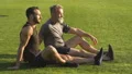 The two men sitting on the grass and talking 4k or 4k+ Resolution