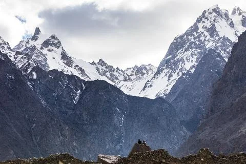 Two men sitting in mountains Stock Photos