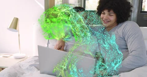 Two men sitting, one using touchpad, starting green-teal dots covering laptop, Stock Footage 323355108