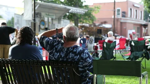 Two men sitting on park bench Stock Footage 27618319