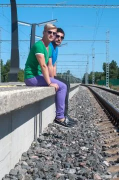 Two men sitting on platform Stock Photos