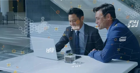 Two men sitting side by side at white table, analyzing data with animated Stock Footage 329690876