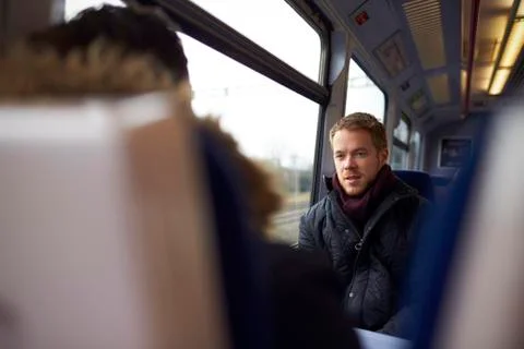 Two Men Sitting In Train Carriage And Talking Stock Photos