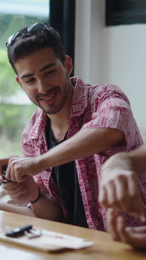 Two men smile as they prepare to smoke Stock-Footage 267505848