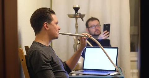 Two men smoke a hookah Stock Footage 86737760