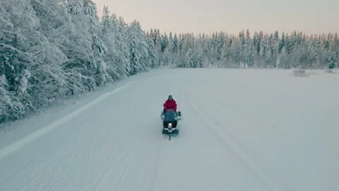 Two men on a snowmobile are preparing the ski track for the sports season. Video stock 167935733