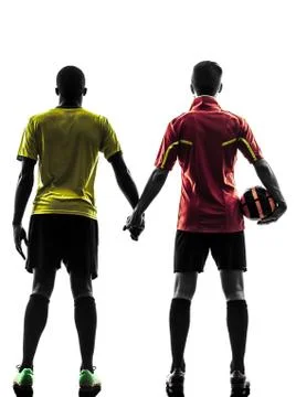 Two men soccer player  standing hand in hand silhouette Stock Photos