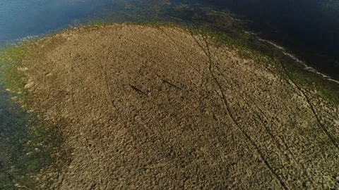 Two men stand in the middle of a spilled river in the spring floods. Stock-Footage 183538891